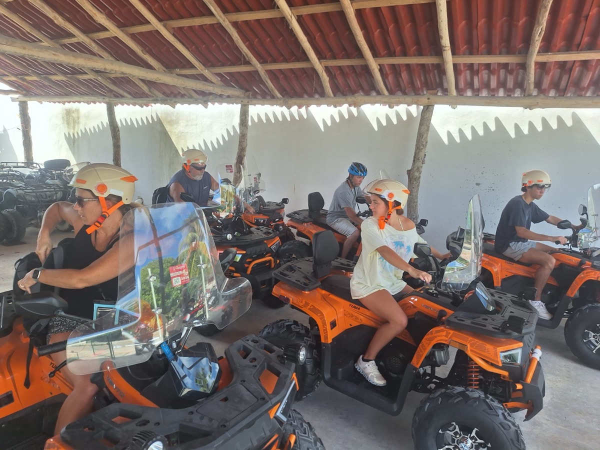 Riders on orange ATVs in Mahahual